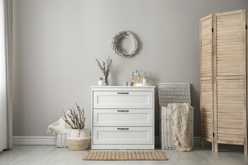 Room interior with pussy willow branches and other decor