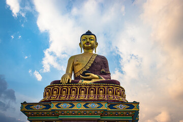 huge buddha golden statue from different perspective with bright blue sky at evening