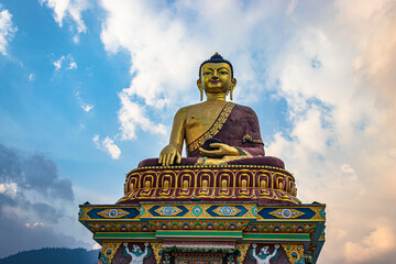 huge buddha golden statue from different perspective with bright blue sky at evening