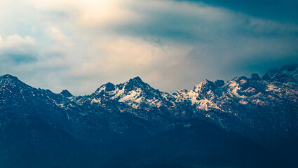 Fototapeta na wymiar himalayan snow cape mountains with dramatic sky at evening