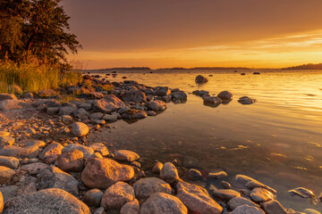 A beautiful sunset in a beautiful scenery illuminated by multi-colored shades creating a beautiful landscape of southern Finland.
