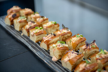 Lobster Rolls on display on a tray at a party. 