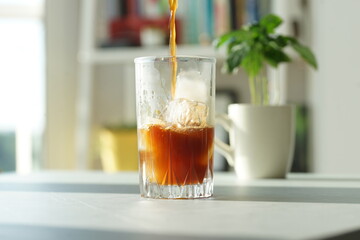 Iced coffee with ice in a tall glass