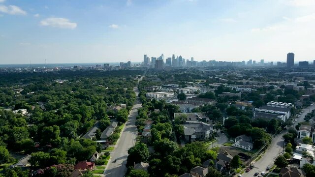 Aerial drone footage moving toward downtown Dallas from east Dallas flying over a residential area and new construction
