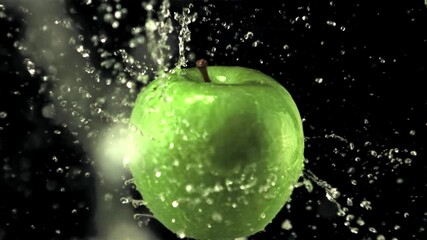 Super slow motion on the rotating apple drops water with splashes. On a black background. Filmed on a high-speed camera at 1000 fps  - Powered by Adobe