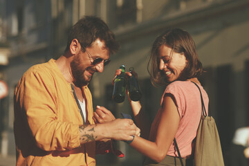 Young happy couple having fun on the street during a summer day