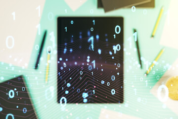 Creative abstract binary code hologram and modern digital tablet on desktop on background, top...
