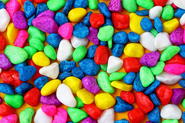 Fototapeta na wymiar close-up colorful painted pebbles background