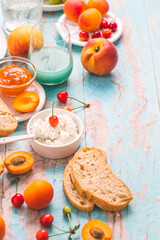 Ricotta cheese with peach and apricot jam, ciabatta, fruits and smoothie