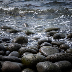 Round stones on a beach, washed with sea water. Hvaleyri Beach, Iceland. 