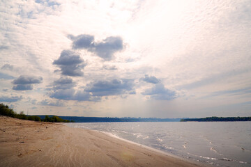 View of a large river with a sandy Bank and forest on the opposite side