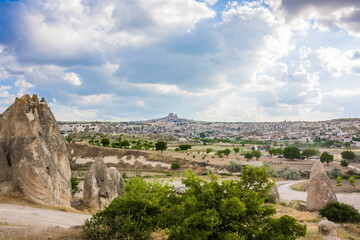 Fototapeta na wymiar Go?reme, Turkey - panorama view of the town of Go?reme in Cappadocia, Turkey with fairy chimneys, houses, and unique rock formations seen from sunrise point