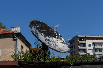 Old satellite dish on the house roof
