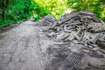 A pile of broken asphalt near the road under reconstruction. Reconstruction of the road near the...