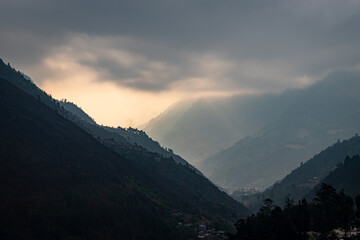 mountain valley with dramatic sky at morning from flat angle