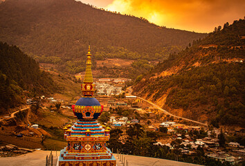 Buddhist stupa with himalayan mountain background and dramatic sky at morning from top angle