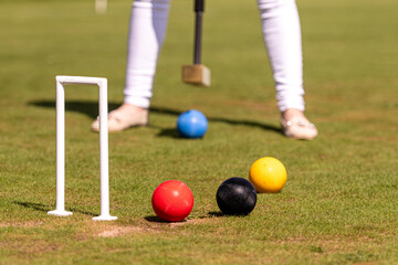 female croquet player hitting the ball with mallet