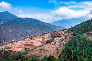 Fototapeta na wymiar mountains with paddy fields and remote village at morning