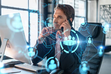 Businessman in suit has conference call to hire new employees for international business consulting. HR, social media hologram icons and interconnections over office background with panoramic windows