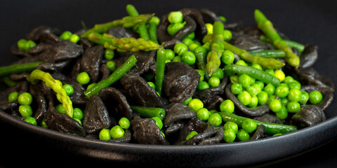 Orecchiette primavera, black pasta with green vegatables