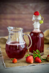 sweet cooked strawberry syrup in a glass decanter