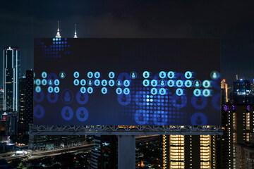 Glowing Social media icons on billboard over night panoramic city view of Kuala Lumpur, Malaysia, Asia. The concept of networking and establishing new connections between people and businesses in KL