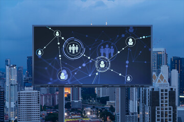 Glowing Social media icons on billboard over night panoramic city view of Kuala Lumpur, Malaysia, Asia. The concept of networking and establishing new connections between people and businesses in KL