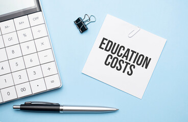 On a blue background, glasses, calculator, coffee, magnifier, pen and notebook with the text EDUCATION COSTS