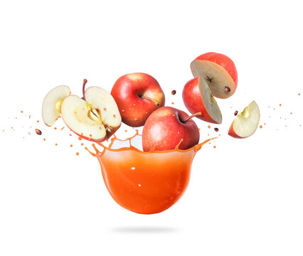 Red whole and sliced apples are falling in splashes of juice
