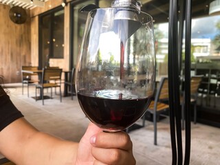 Woman pouring wine out of the wine aerator decanter