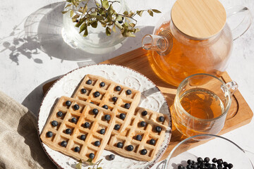 Homemade belgian waffles with berries and tea
