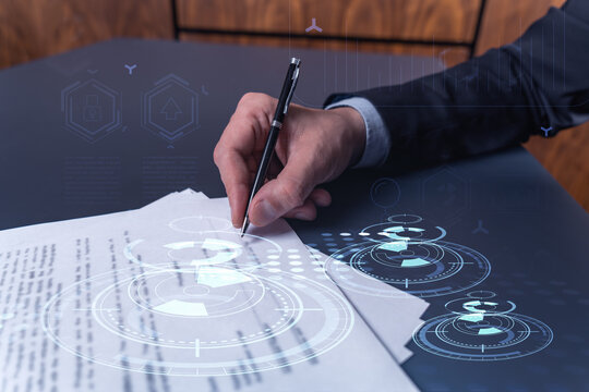 A Client In Dark Blue Suit Is Signing A Contract To Create A New Software To Present It In Start Up Conference And Gain Investments To Create A Product. Technological Graph Over The Desk.