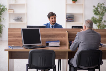 Two male employees working in the office