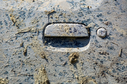 A Door Handle With A Keyhole Of A Car Covered With A Layer Of Mud From A Dried Bog To The Body Of An SUV A Close-up Texture, Nobody.