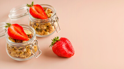 Keeping a healthy breakfast. Muesli with fruits and strawberries on a pink background. Granola healthy food dessert snack. Diet concept. Vegetarian food. Copy space