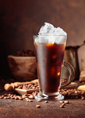Ice coffee in frozen glass and coffee beans.