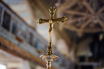 Jesus on Cross golden statuette inside a Church