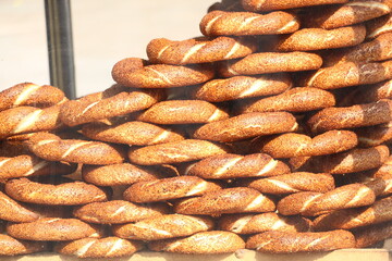 Selective focus street bagels sold as street food in the crowded Eminönü district and a donut known as Açaç