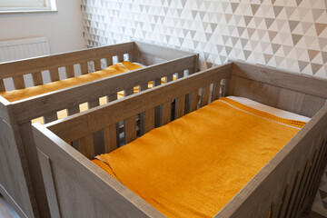 A Twin Bedroom with wooden baby beds for siblings, newborn babies modern stylish interior