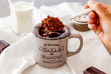 Vegan chocolate cake in a white ceramic mug. Ready to Eat