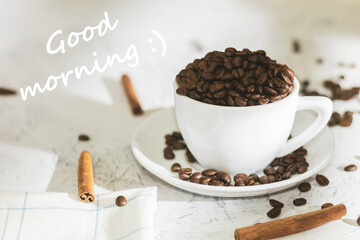 White cup with coffee beans and the text good morning
