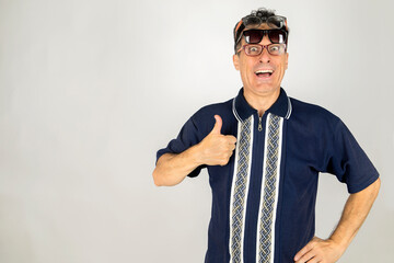 Goofy guy with two pair of glasses on face with a thumb up expression celebrating vacation time. White background and Copy Space.