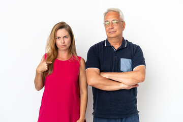 Middle age couple isolated on white background annoyed angry in furious gesture
