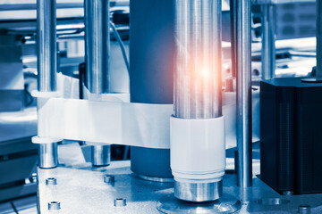 Fragment of the conveyor of sticking labeling machine. Abstract industrial background.