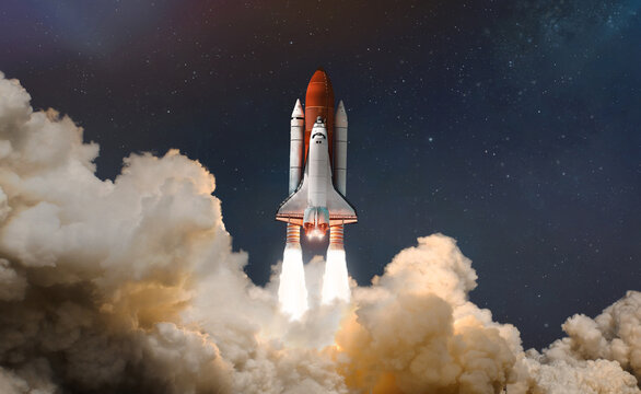 Space shuttle launch in the clouds to outer space. Dark space with stars on background. Sky and clouds. Spaceship flight. Elements of this image furnished by NASA