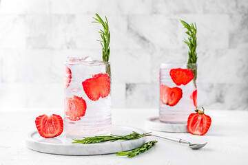 Two highball collins glasses of refreshing strawberry rosemary sparkling lemonade. Light and bright...