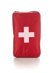 Red first aid medical kit bag standing over white