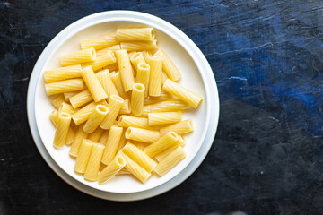 pasta in a plate on the table macaroni ziti penne italian cuisine healthy food meal snack copy space food background rustic. top view