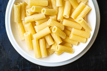 pasta in a plate on the table macaroni ziti penne italian cuisine healthy food meal snack copy space food background rustic. top view