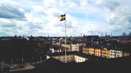 Swedish Flag with view of Stockholm buildings - 443487495
